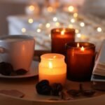 Burning,Candles,,Lights,,Coffee,,Book,And,Decor,On,Bed,Indoors,